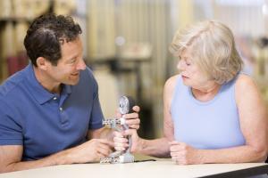 Occupational Therapist testing a womans grip strength